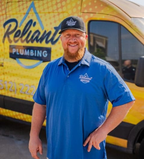 Fieldstone employee posing in uniform in from of a yello work truck