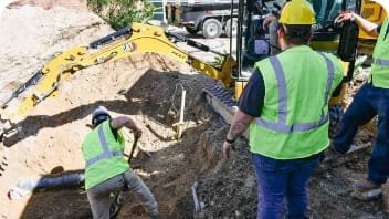 workers using mechanical service excavator